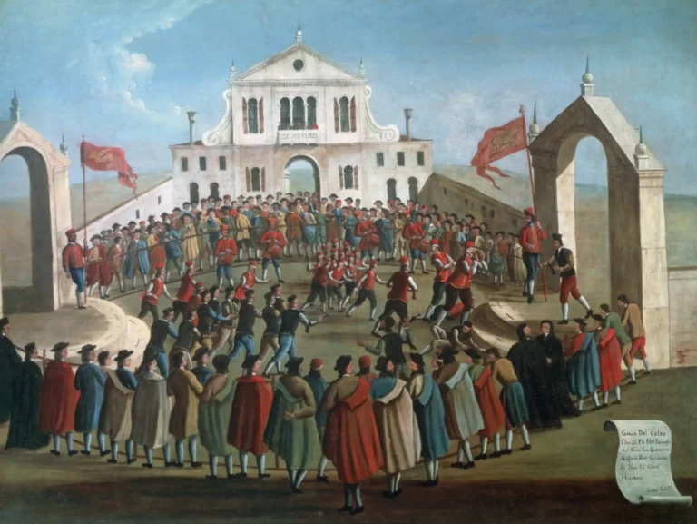 In this painting, we see the entire playing field from the side, with an ongoing game.
The field is elongated, but not rectangular. It is oval, delineated by a simple fence, going in a curve from goal to goat.
The goals are actual gates, like you would find on a fine house. They're arched, with decorations on top. They're not level with the playing field, but raised two steps up on a small dais.
The two teams are numerous, one wearing red waistcoats and matching hats, the other in black or brown. Trousers and shirts are in varying colours.
A member of the red team is running with the ball in his hands towards the gate on the right, which is blocked by a player in black. Some players, of both teams, have fallen to the ground.